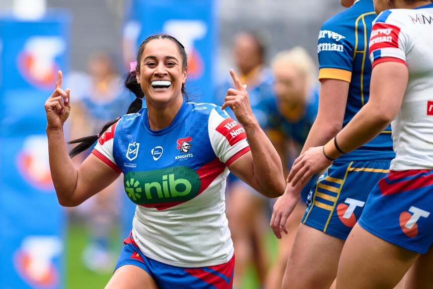 A Newcastle Knights NRLW player celebrates a try against the Parramatta Eels.