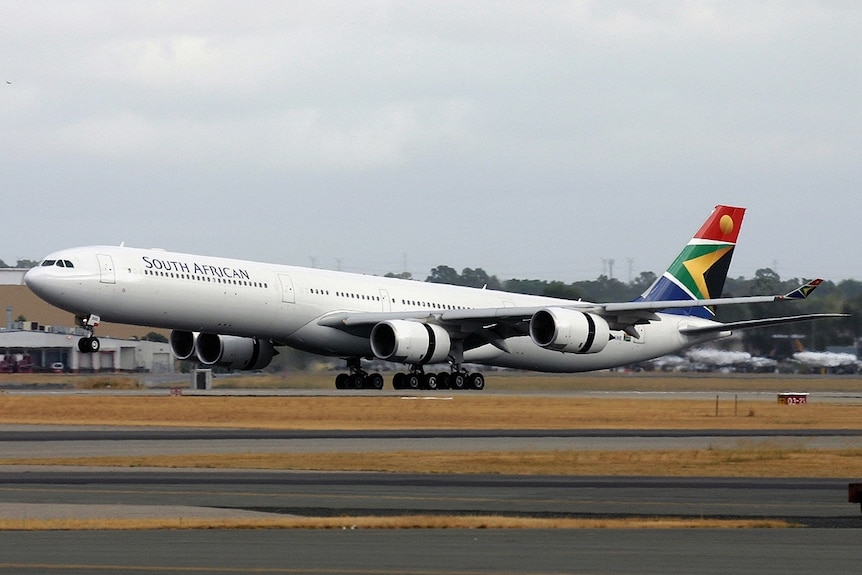 A passenger jet sits in a large, open area.