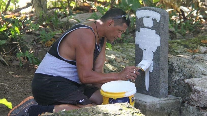 Aaron Hansen restoring a grave