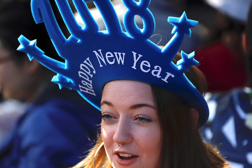 A spectator waits for the annual new year fireworks as part of celebrations on Sydney Harbour, Australia