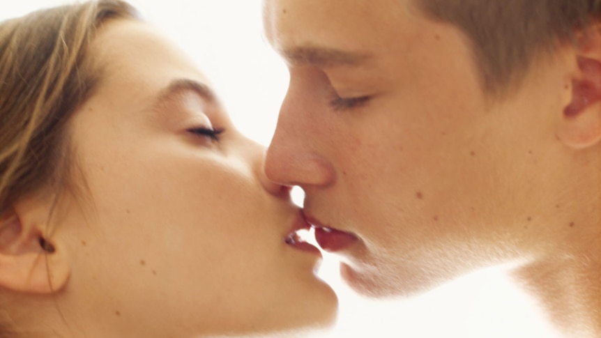Close-up of a teenage couple kissing