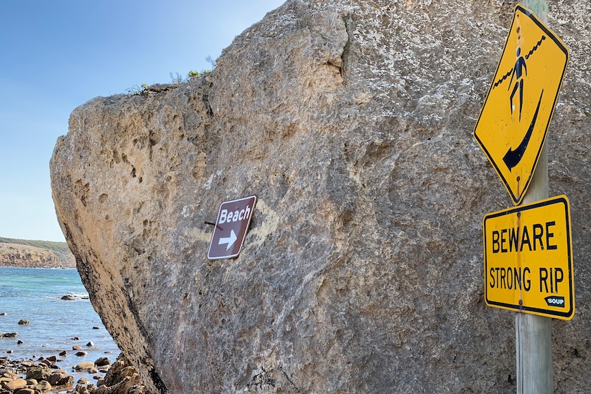 A sign warning of a strong rip at Stokes Bay.