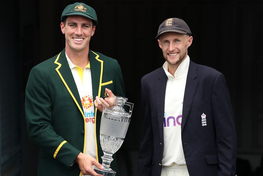 The Australian and England men's Test cricket captains stand with the Ashes trophy.