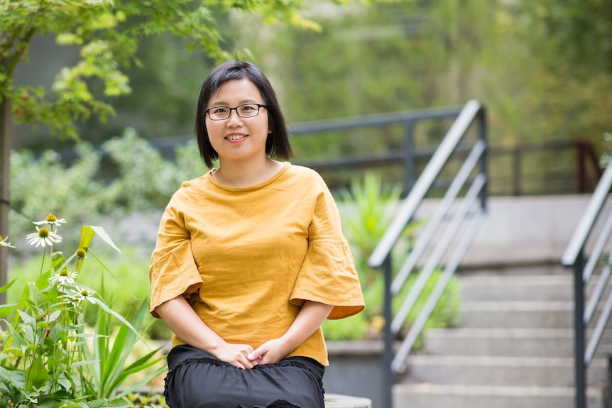 A woman sit in a park