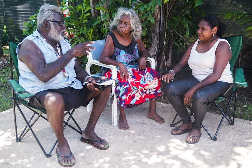 Kenisha Gumbala sits outside with older members of her family at home in Darwin.