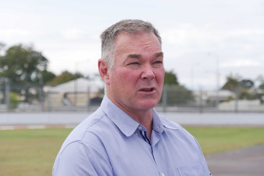Headshot of Scott Stewart speaking to media at a raceway in Townsville.