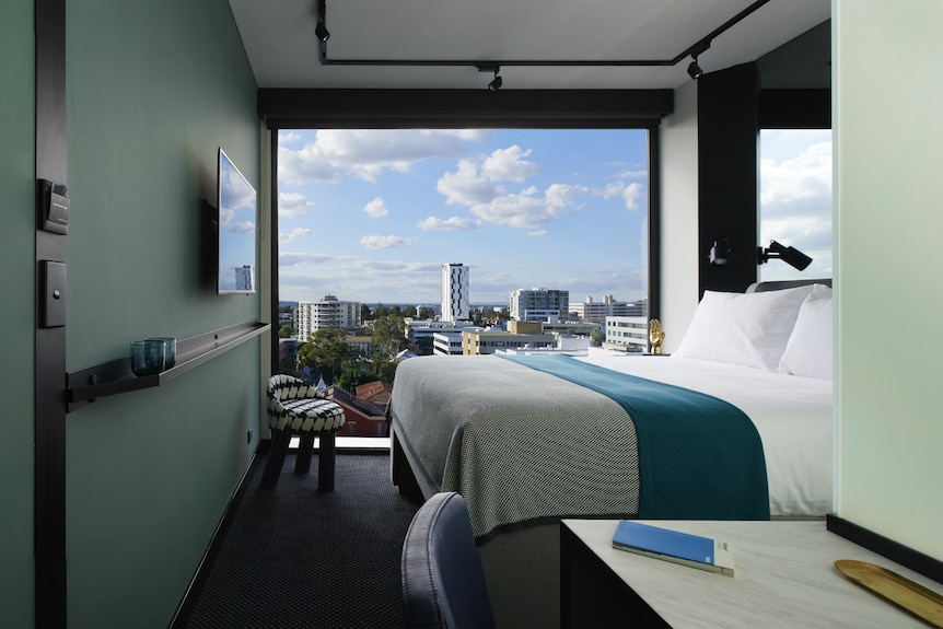 A room at the Tribe Hotel in Perth with a view of the city skyline.