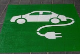 A painted image of a white car, with an electrical cord attached, on a green background. 
