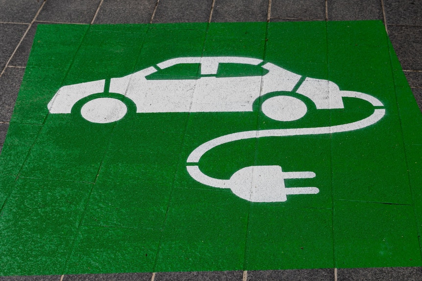 A painted image of a white car, with an electrical cord attached, on a green background. 