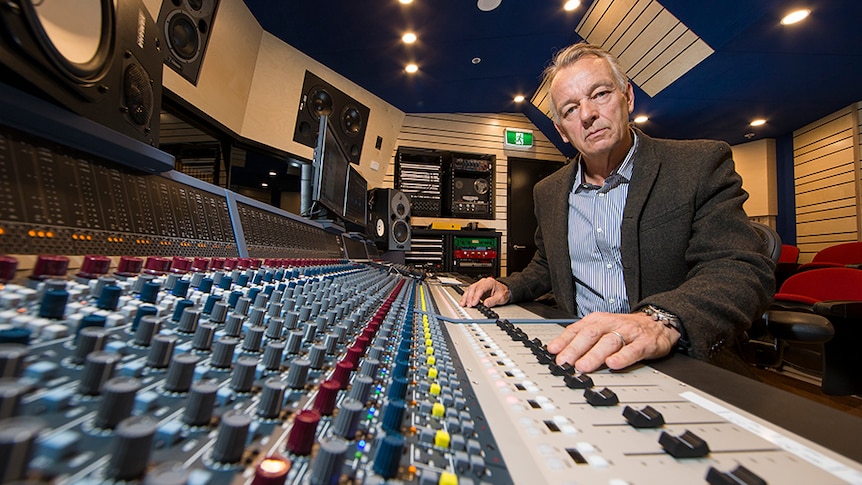 Mark Opitz sits in a recording studio.