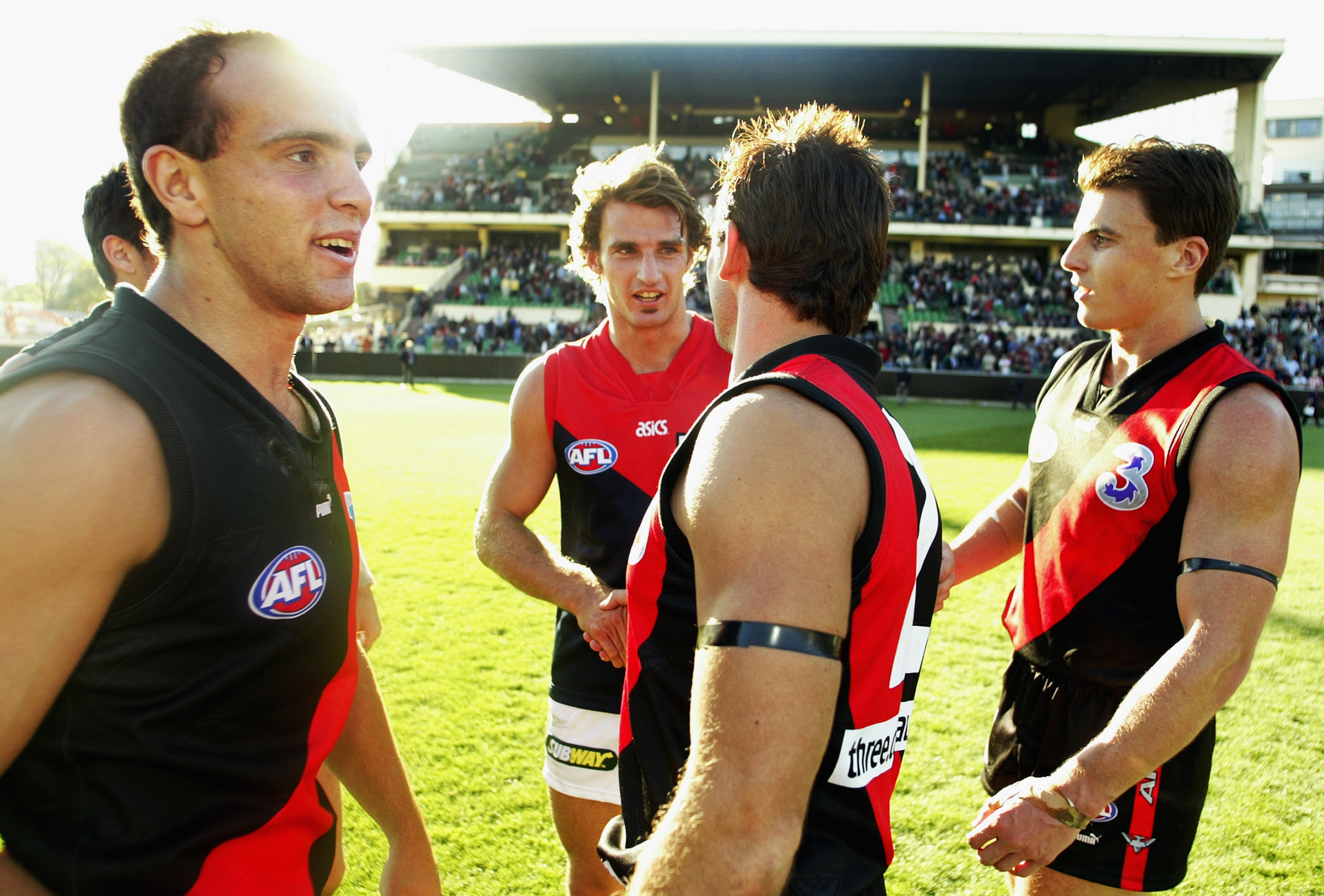 Chris Heffernan shakes hands with old Essendon teammates