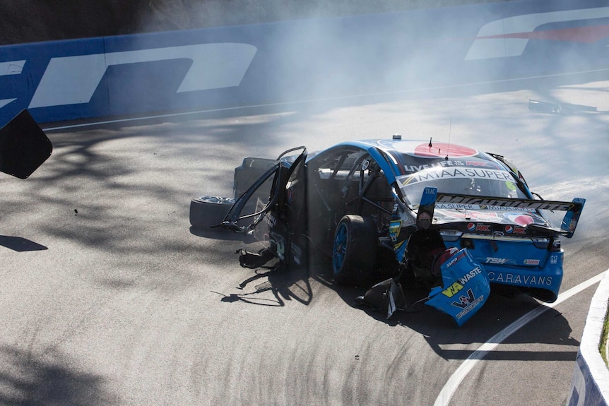 A smashed up car on the track at Mount Panorama