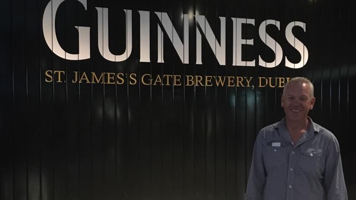South Australian Police Commissioner Grant Stevens stands in front of a sign at the Guinness factory in Dublin.