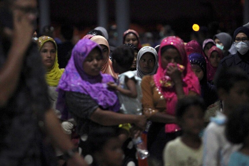 A number of Rohingya refugee women stand together.
