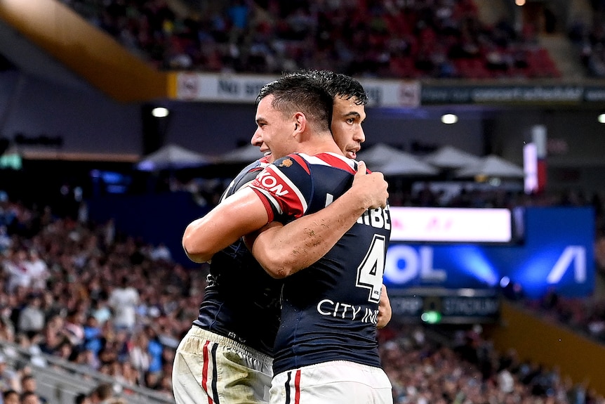Sydney Roosters teammates Joseph Sua'ali'i and Joey Manu hug during an NRL game.