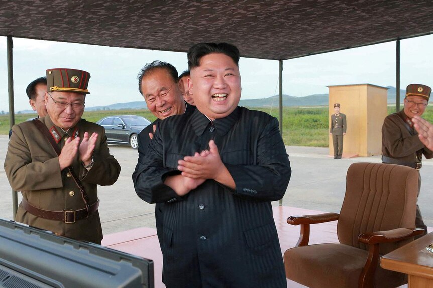 North Korean leader Kim Jong Un guides the launch of a Hwasong-12 missile.