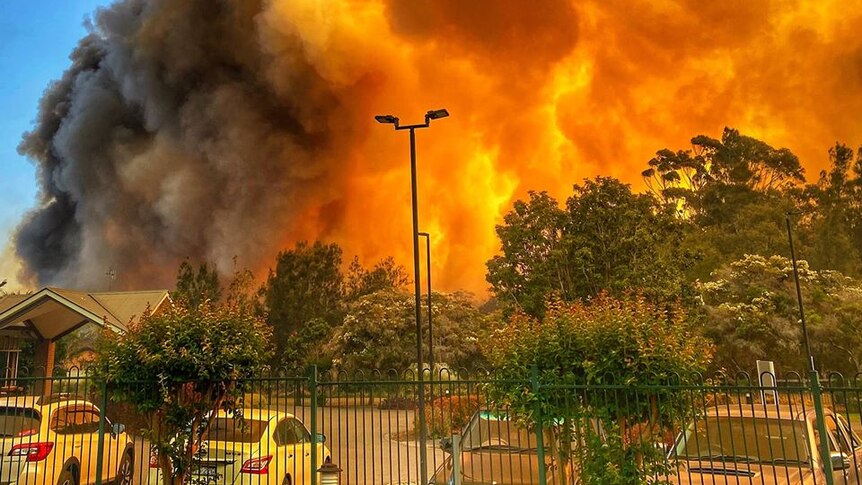 Sky-high flames surround a car park