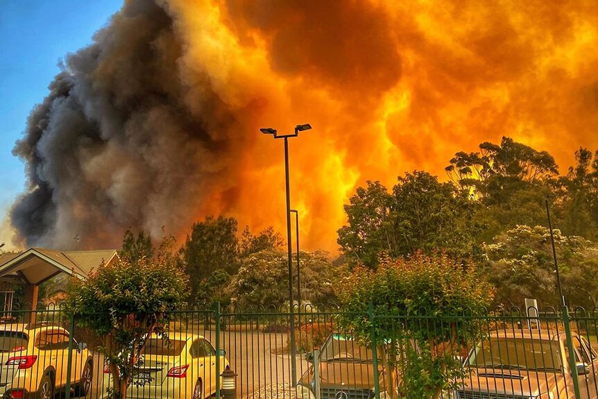 Sky-high flames surround a car park