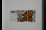 A photo of the art piece of Winnie the Pooh on a Yuan. 