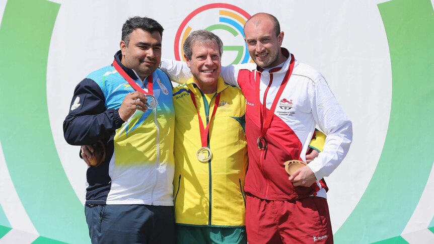 Australian gold medallist Warren Potent with Indian Gagan Narang (silver, L) and England's Kenneth Parr (bronze, R) after the men's 50m rifle prone event