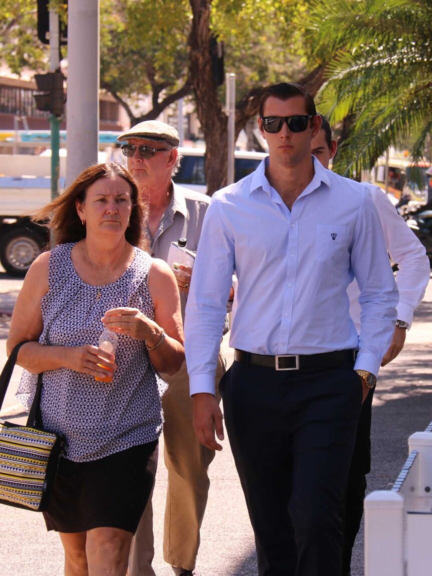 Thomas and William Lichtenberg-McGill walk to court in Darwin, accompanied by their parents.