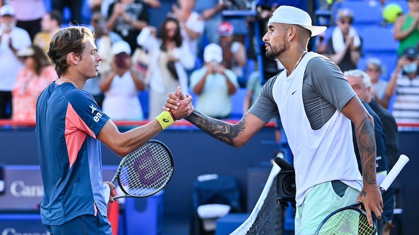 Alex de Minaur and Nick Kyrgios shake hands across the net after a match at the Montreal Masters ATP tennis tournament.