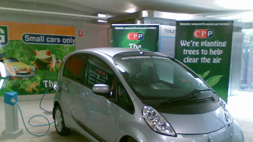 Electric car parked in City of Perth carpark next to recharging station