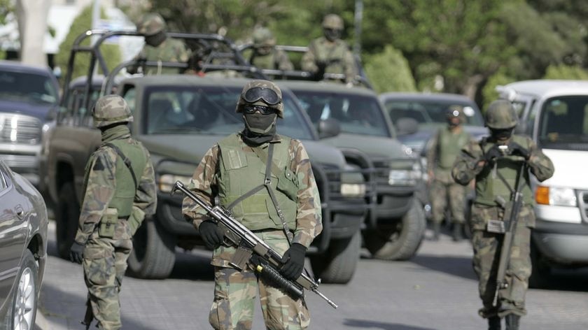 Mexican soldiers stand guard on a street in Juarez