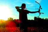 A hunter uses a bow and arrow