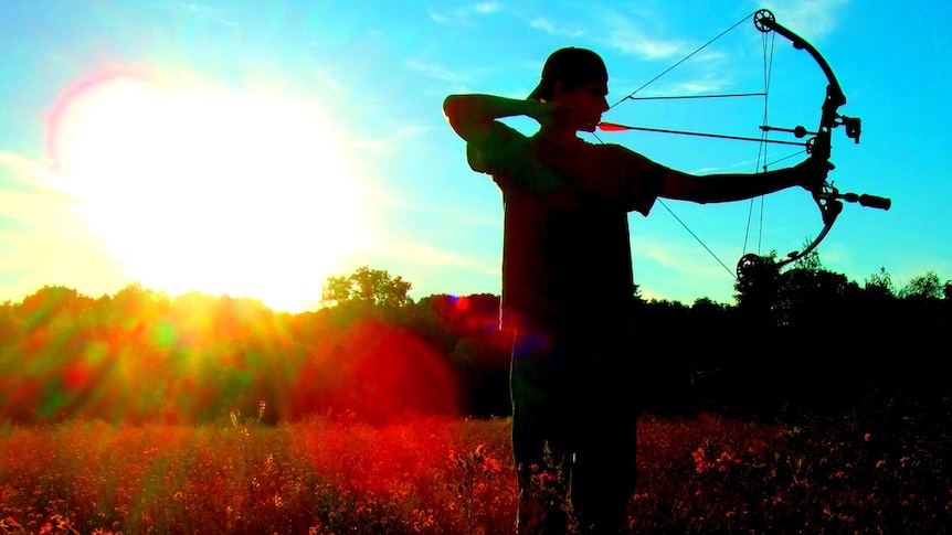 A hunter uses a bow and arrow