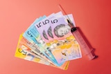 A graphic image shows Australian cash and a syringe lying on a red background.
