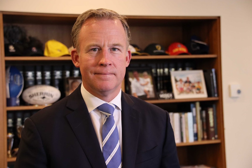 Tasmanian Premier Will Hodgman stands in his office.