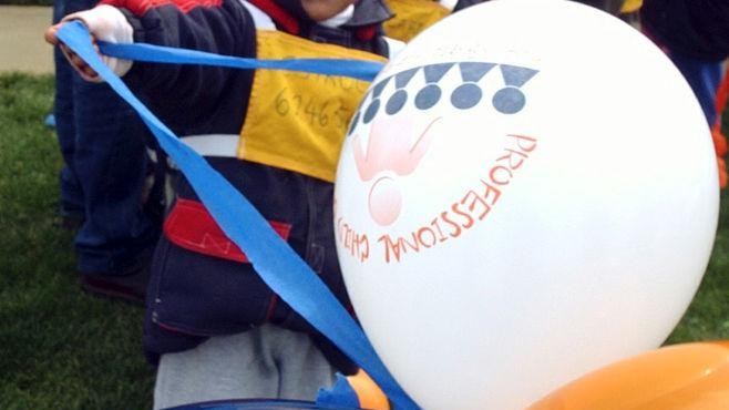 Child holding balloons at a party