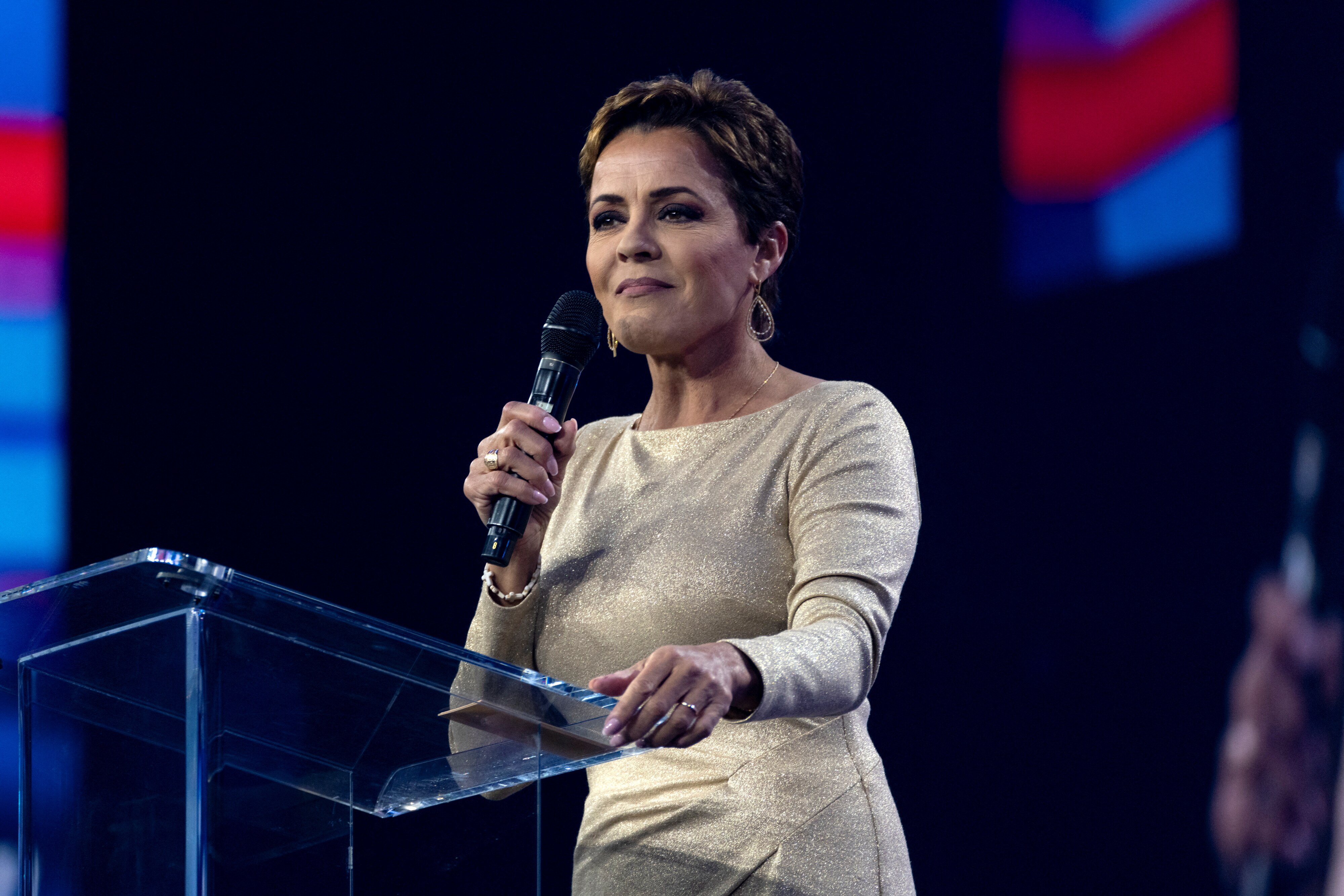 A woman stands at a podium.