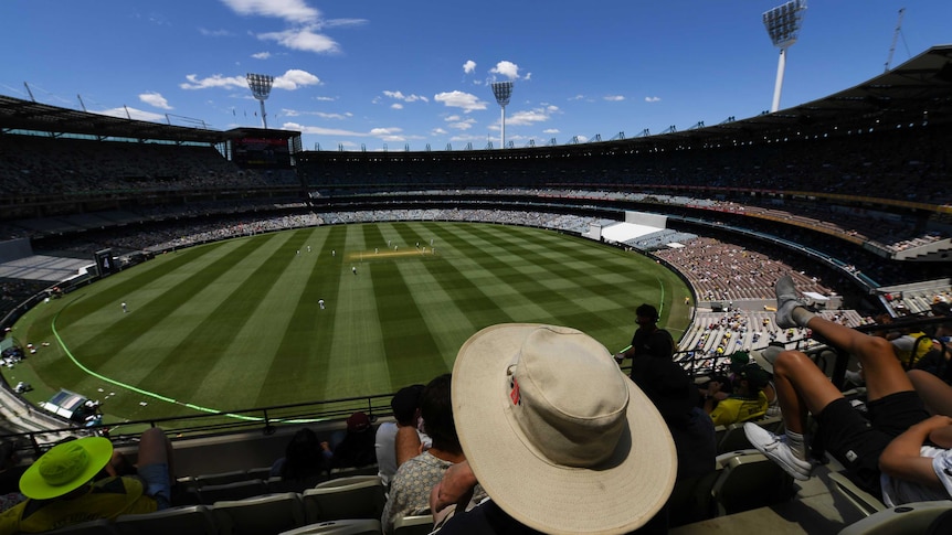 A shot from the stands shows the MCG grounds, with socially distances crowds in the stands