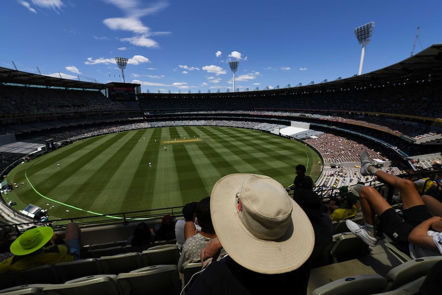 A shot from the stands shows the MCG grounds, with socially distances crowds in the stands