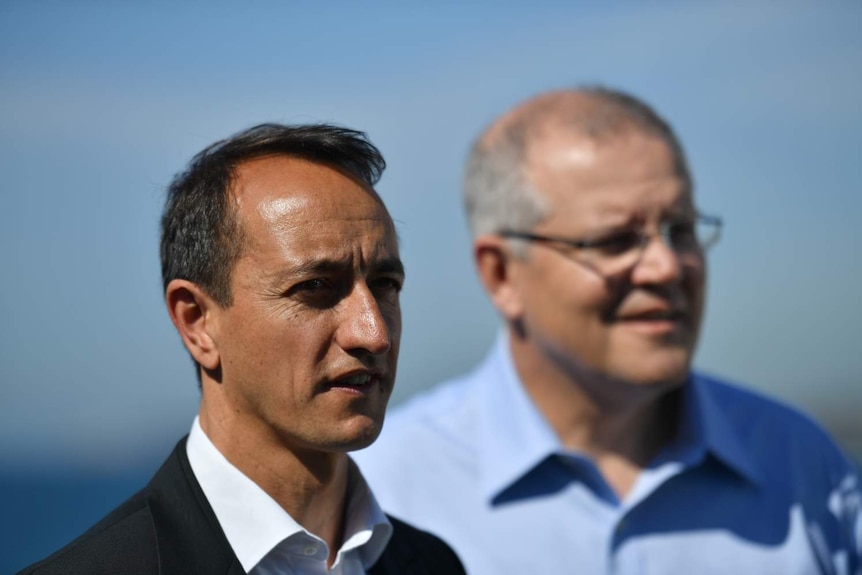 Wentworth candidate Dave Sharma talks with Scott Morrison, blurry, in the background.