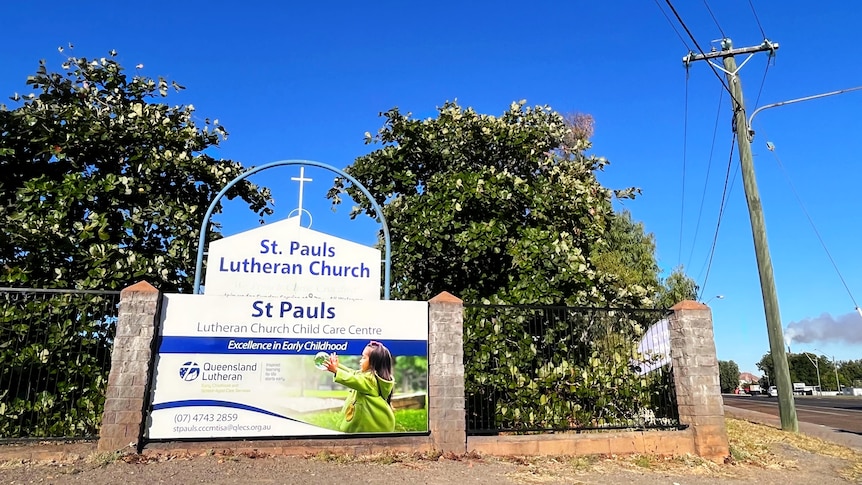 A shot of the front of a church building with a sign reading St Paul's Lutheran Church