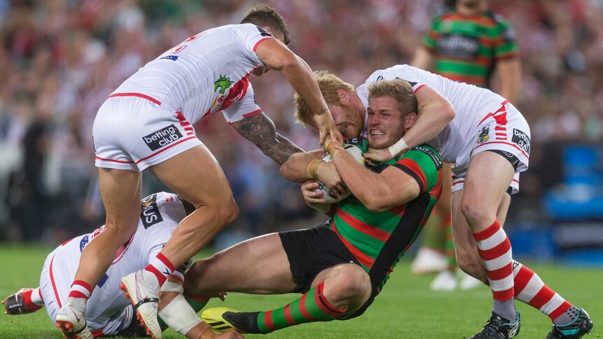 Tom Burgess is tackled by the Dragons