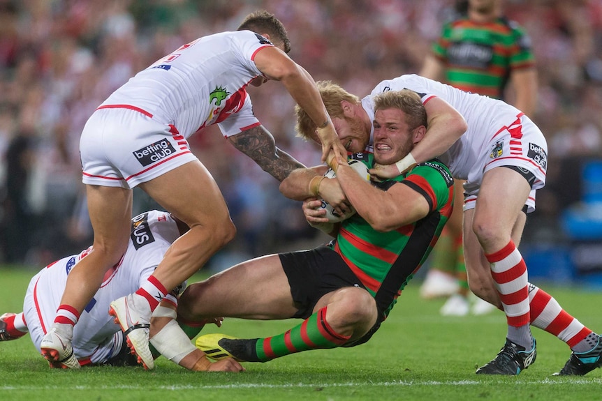 Tom Burgess is tackled by the Dragons