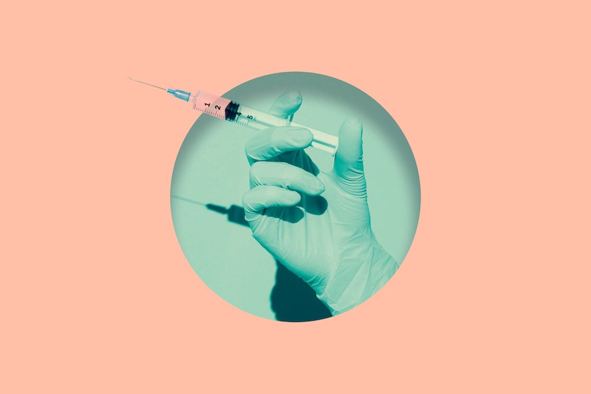 Doctor's hand holding syringe of COVID vaccine placed inside round hole in pink paper.