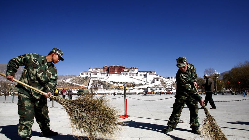 Soldiers sweep the Potala Palace square in Lhasa, Tibet Autonomous Region March 7, 2009.