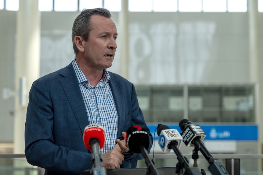 WA Premier Mark McGowan speaking into microphones at a media conference.