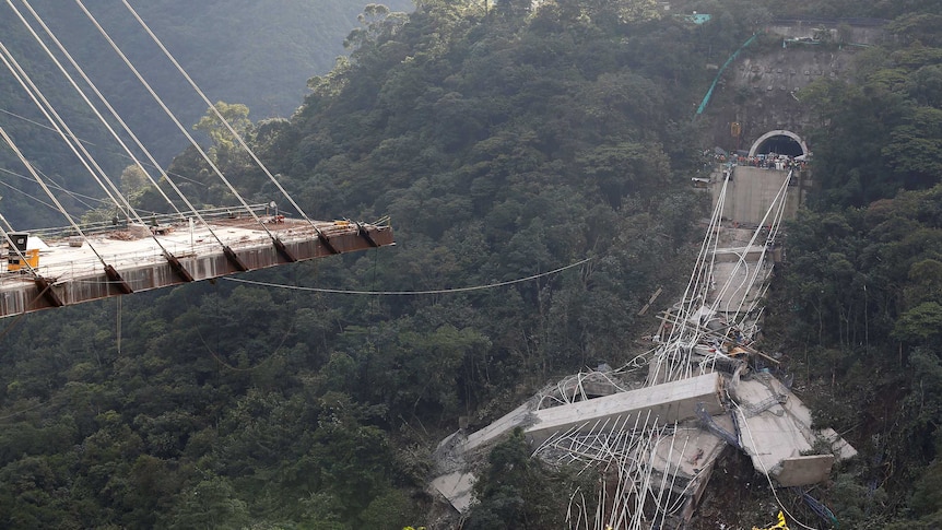 View of a bridge under construction that collapsed over a lush valley in Colombia
