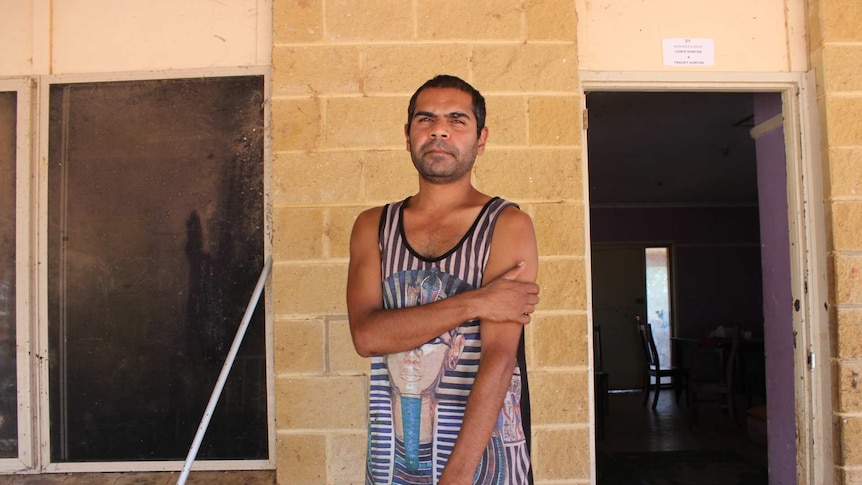 Chris Hunter Barkindji man stands out the front of a house he lives in