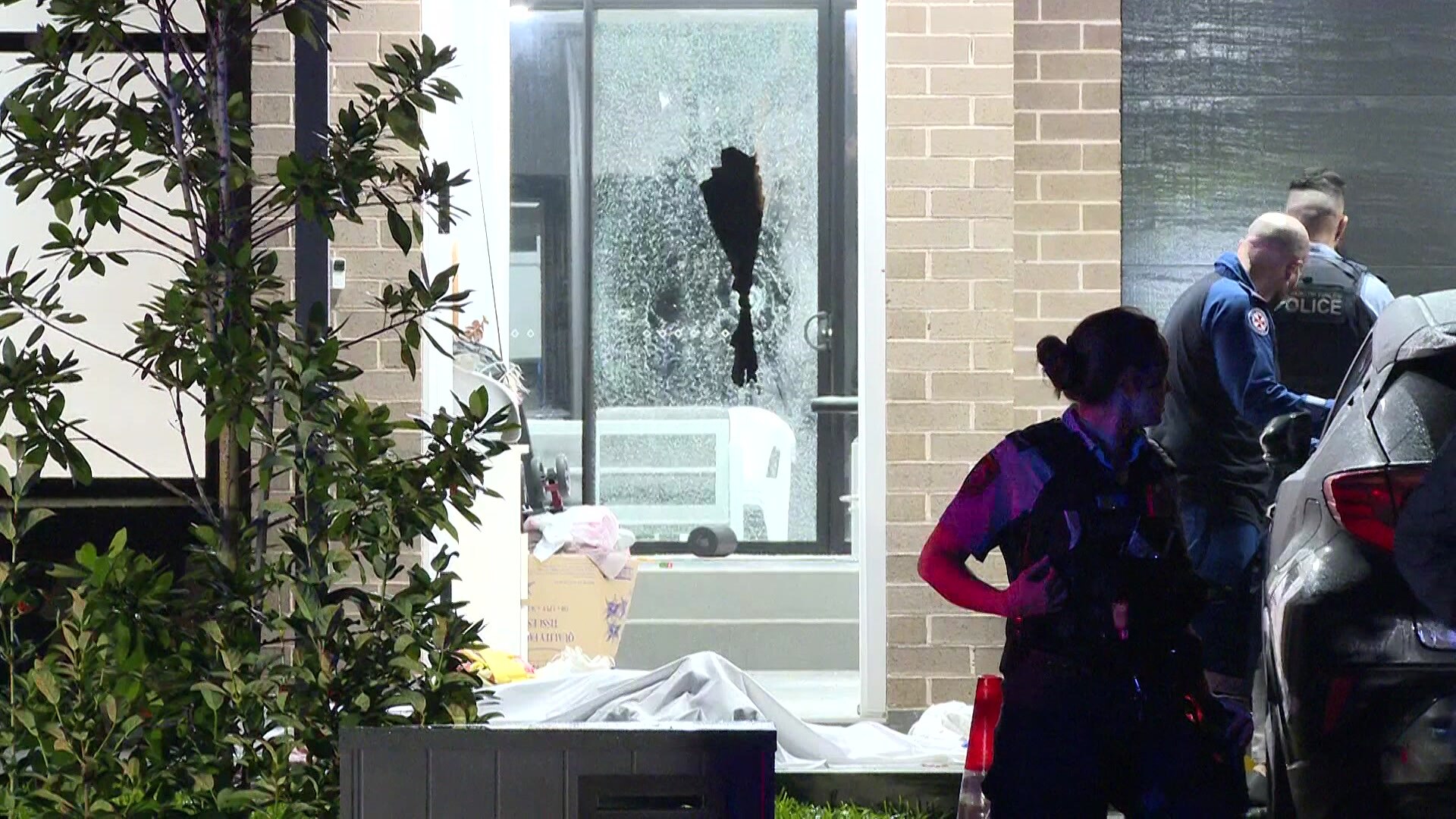 nsw police out the front of a house after a shooting