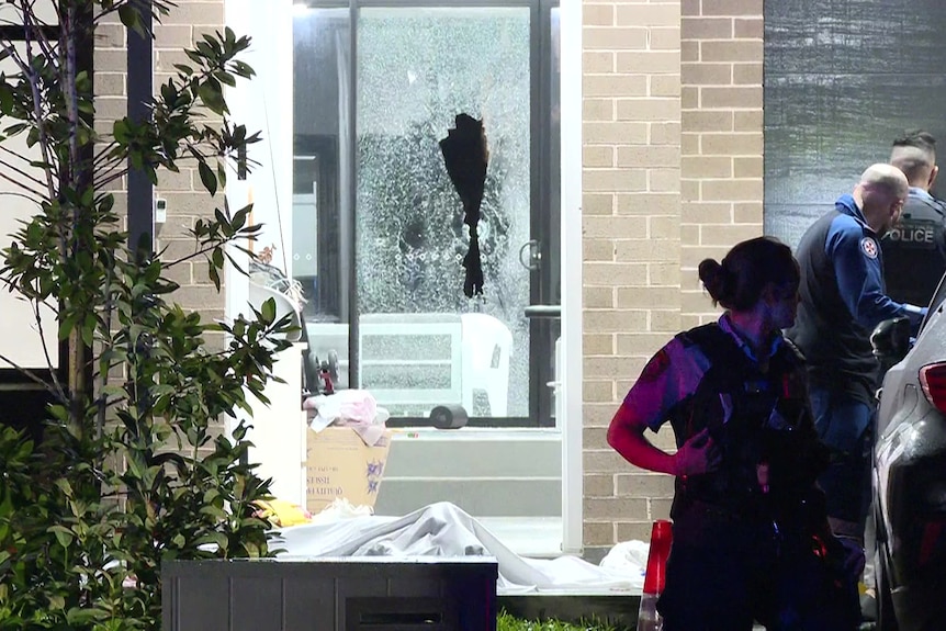 nsw police out the front of a house after a shooting