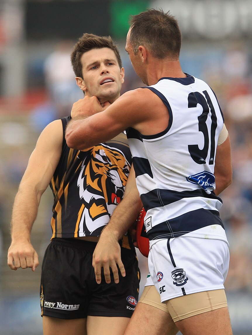 James Podsiadly of the Cats goes toe-to-toe with Trent Cotchin of the Tigers.