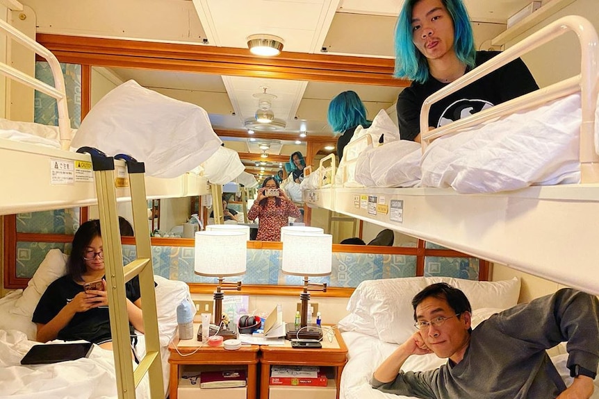 Two teenagers in bunk beads in a tiny cruise ship cabin