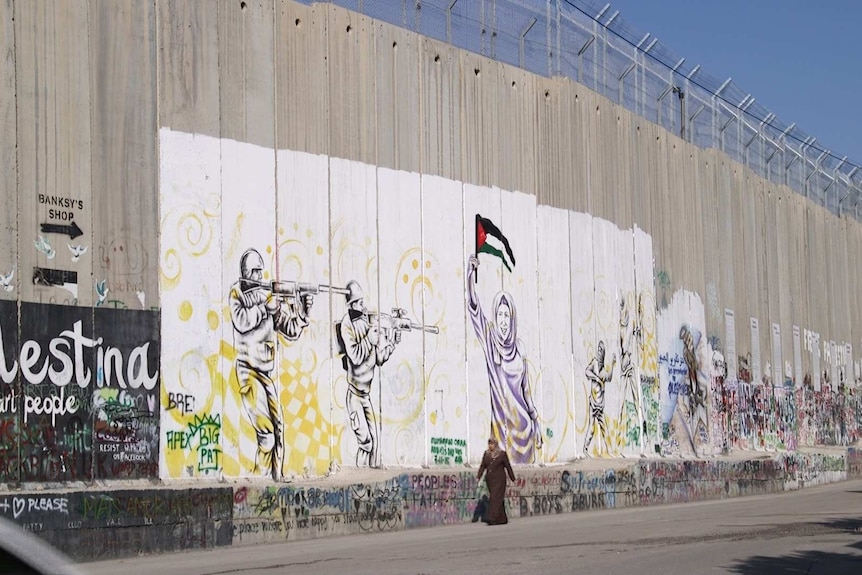 The separation barrier with graffiti and pictures painted on it